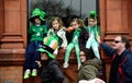 Four children sat by the window and hold by their parents on St. Patrick`s Day ParadeÃÂ in Dublin, Ireland, March 18th 2015